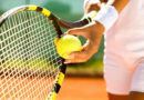 Player’s hand with tennis ball preparing to serve